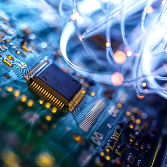 Fibre optics carrying data passing through electronic circuit boards, close up